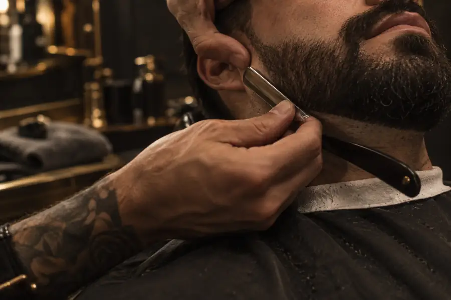 Barber shaping a beard